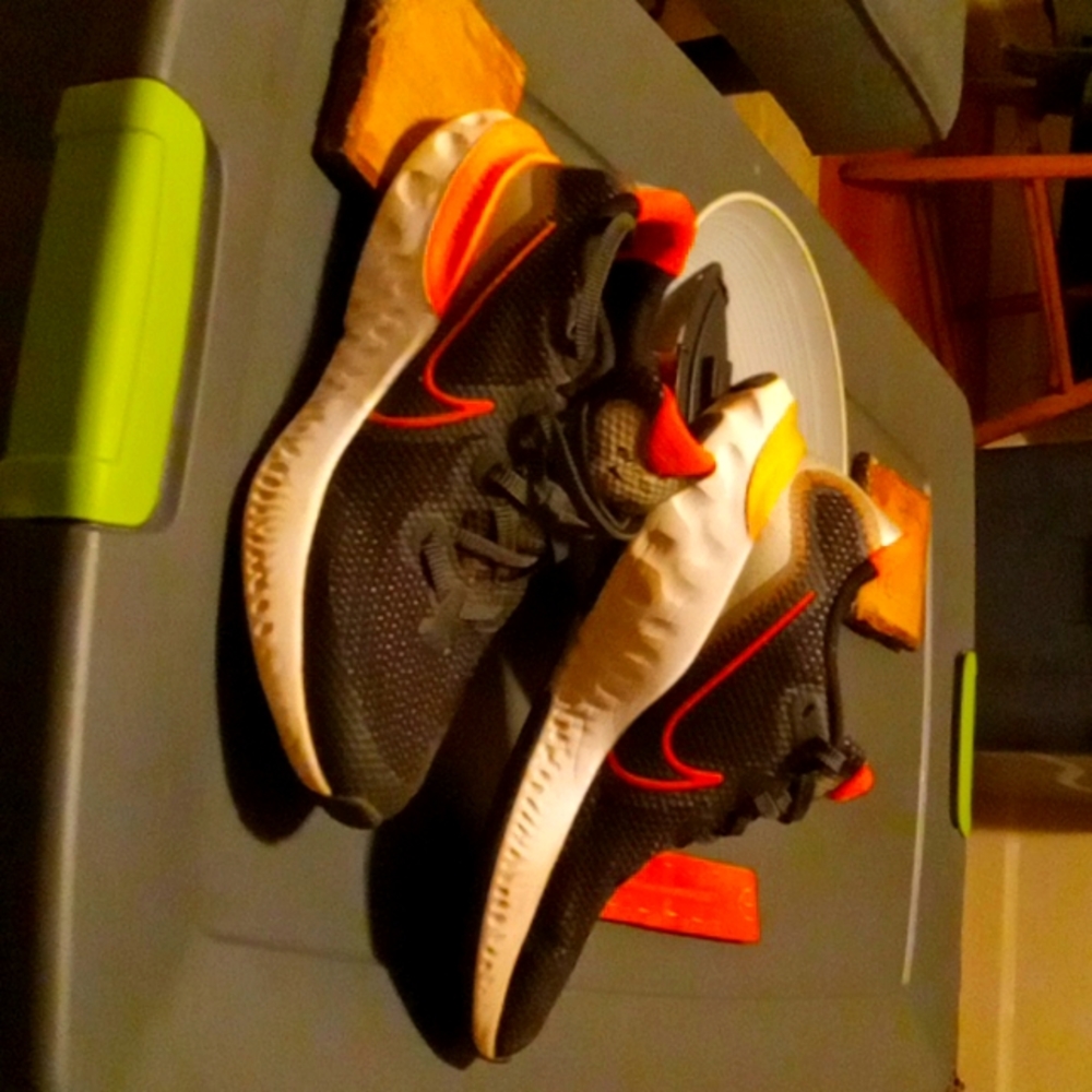 Nike shoes. Size 5.5 boys. Black and orange. Original price average is $70.00.